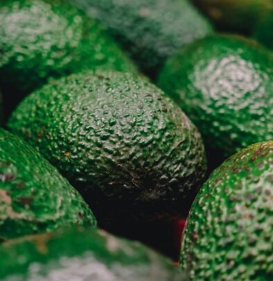 a pile of green avocados sitting next to each other
