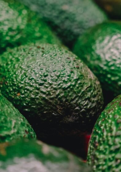 a pile of green avocados sitting next to each other